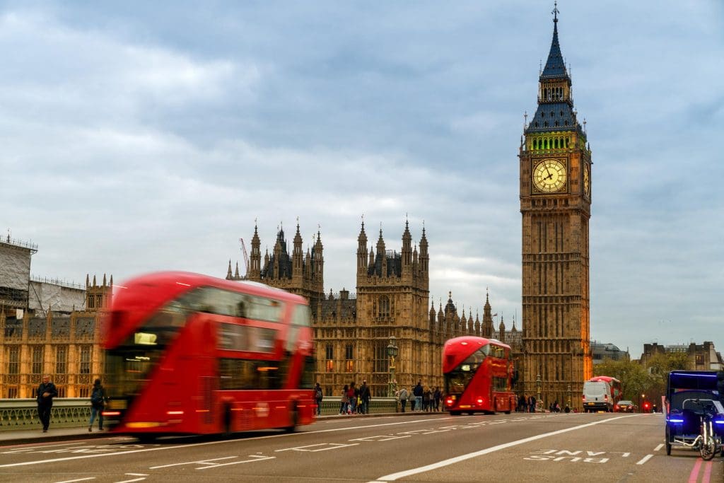 large clock tower towering over a city with electric car charging points in London