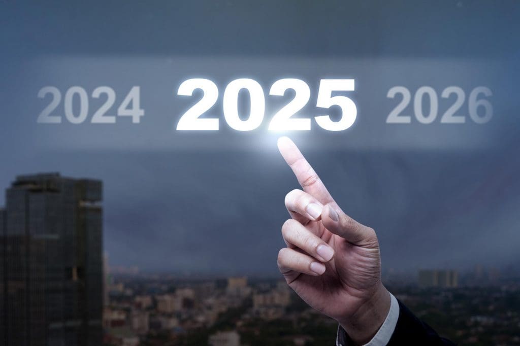 man in a suit pointing to a sign that reads 2025, ev lifestyle uk