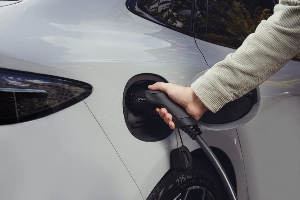 person pumping gas into a car at a gas station