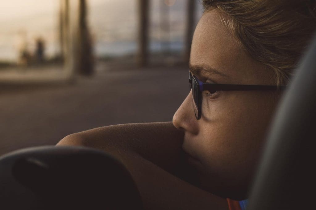 woman wearing glasses sitting in a car