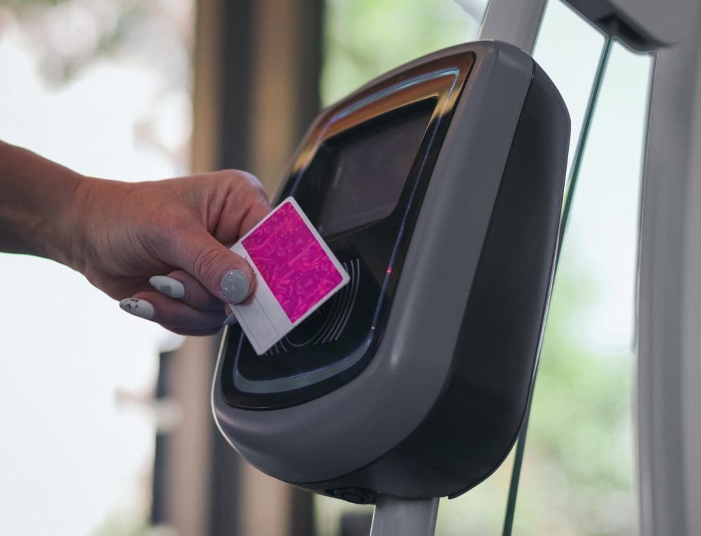 person using a card reader on a machine for secure EV charging payments
