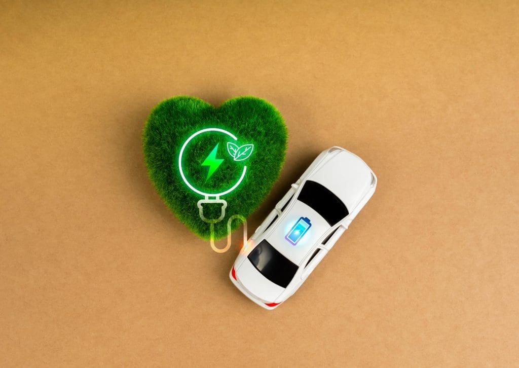 car is parked next to a green heart, highlighting the importance of EV battery health
