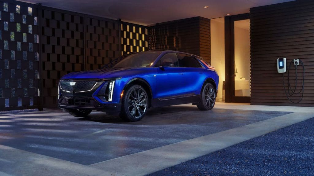 blue Cadillac EV UK parked in front of a building