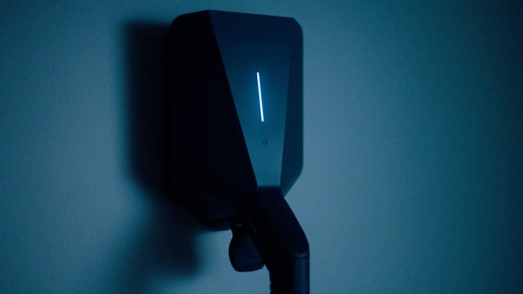 wall mounted phone hanging on a blue wall, ideal for use with the best home charger UK 2025