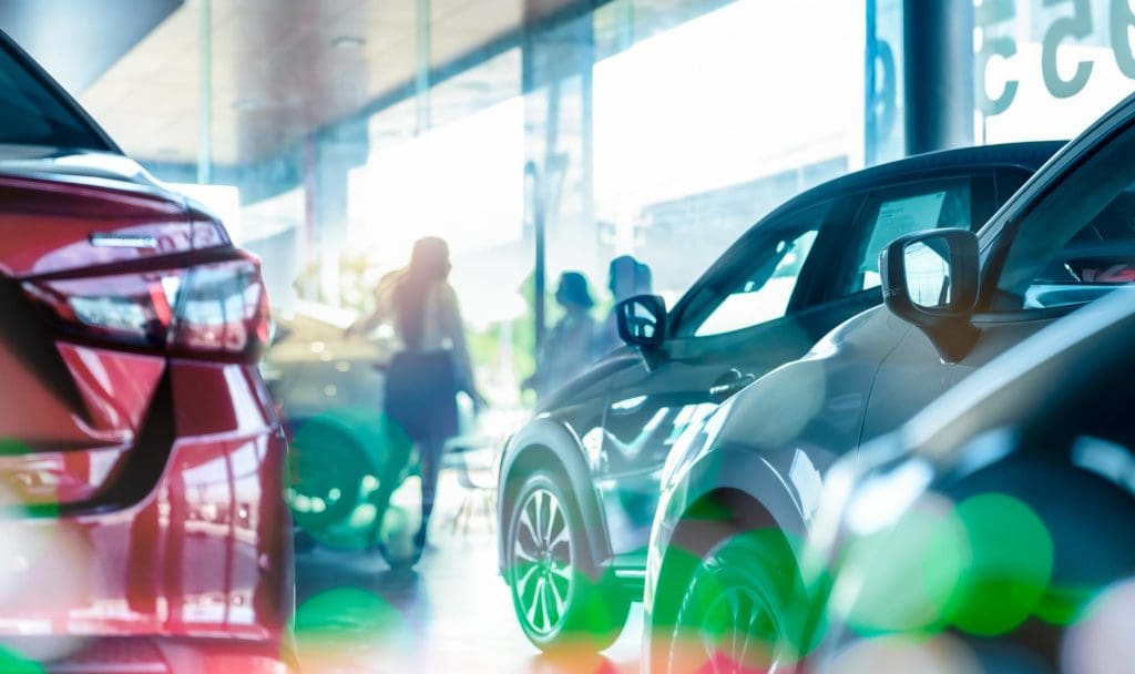 Electric cars displayed inside a modern UK dealership