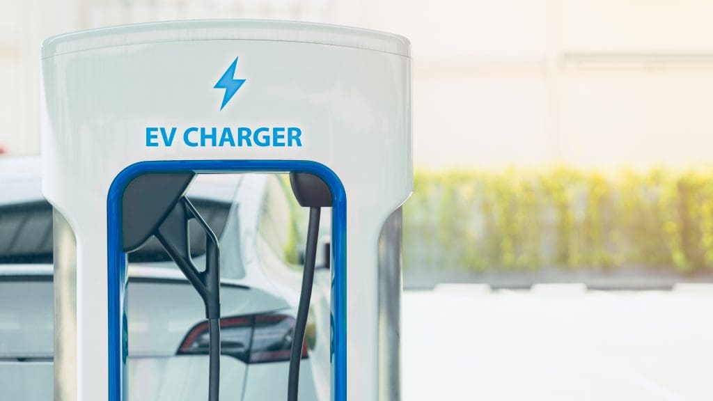 ev charger is shown in a parking lot, representing one of the cheapest ev charging stations near me