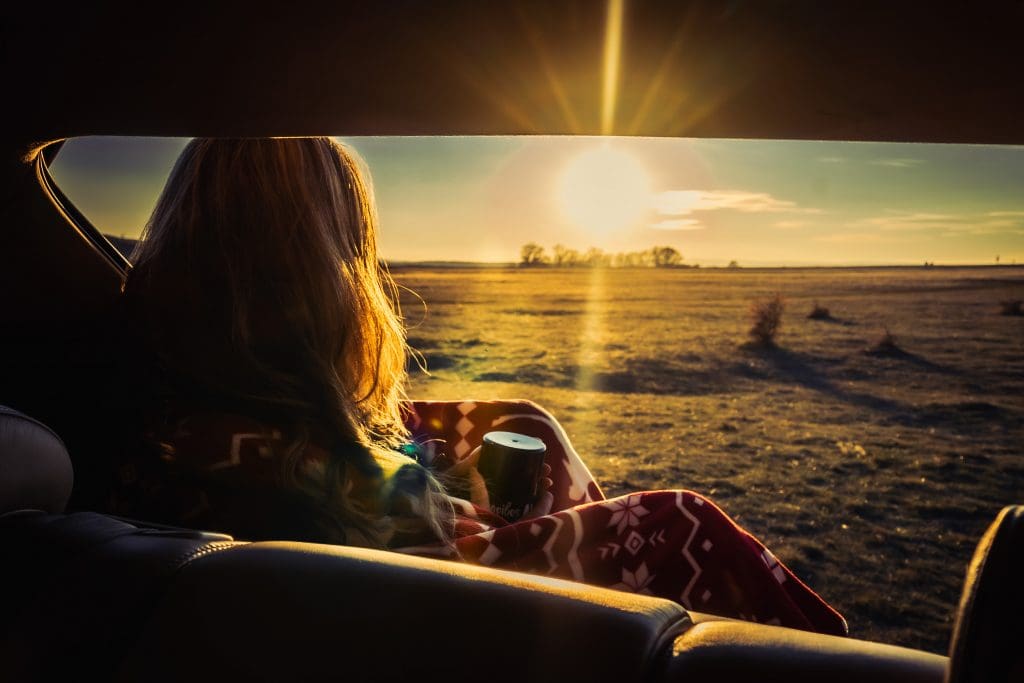 woman sitting in the back seat of a car during a 2025 UK EV summer road trip checklist